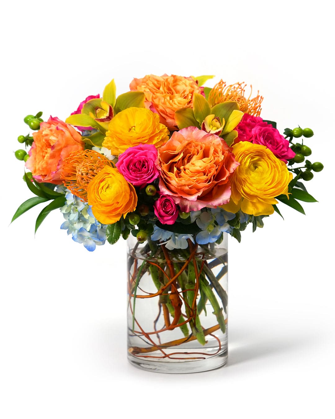 Vibrant flower bouquet featuring roses, ranunculus, and orchids in a clear vase, perfect for any occasion.