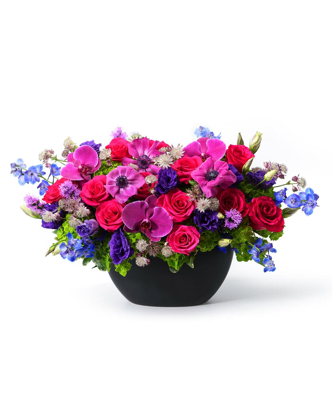 Vibrant floral arrangement featuring pink roses, orchids, and blue delphiniums in a sleek black vase.